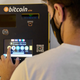 A m,an using a General Bytes cryptocurrency ATM in Palma de Mallorca, Spain in August 2021.